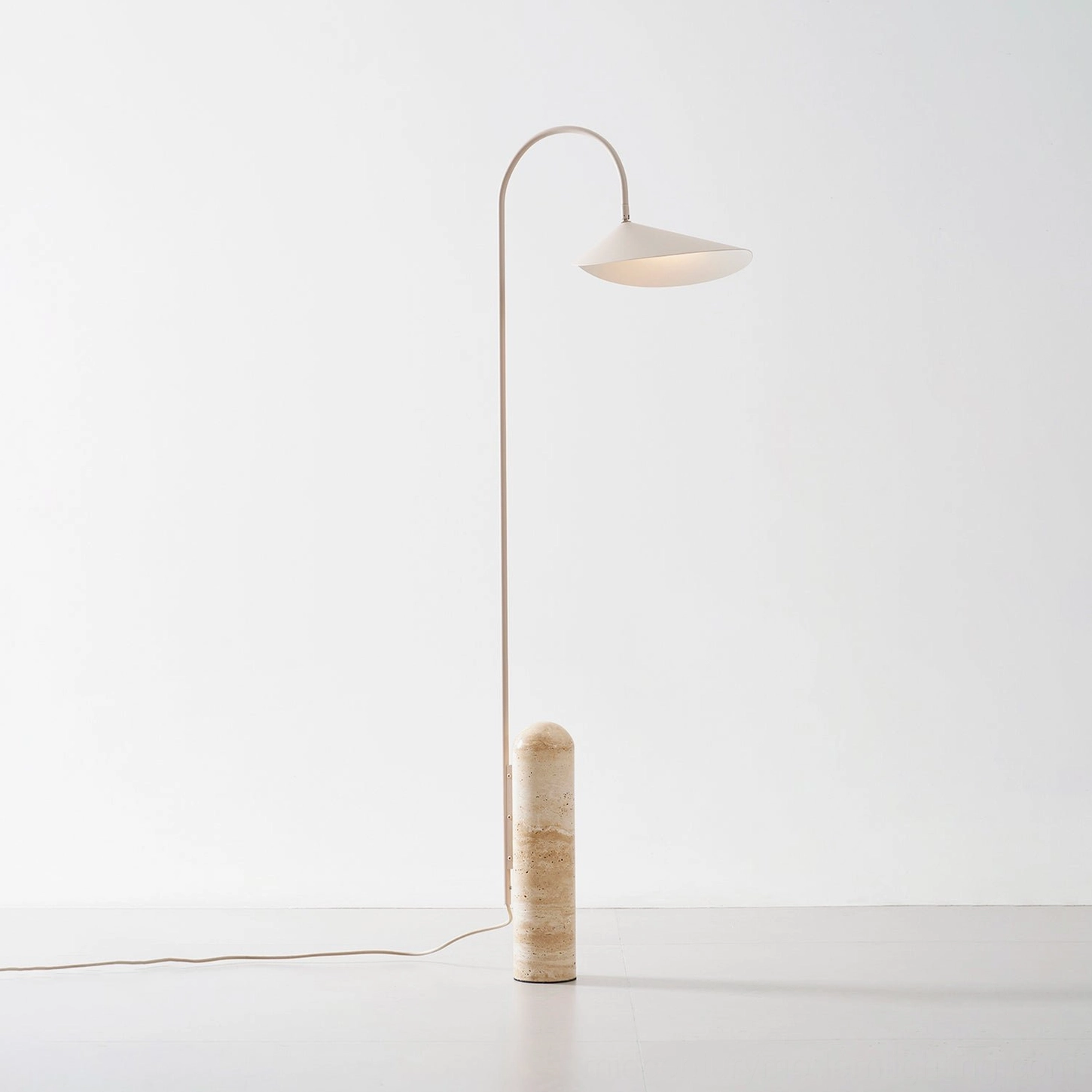 Mono floor lamp sculptural form with curved metal arm and natural stone base architectural detail