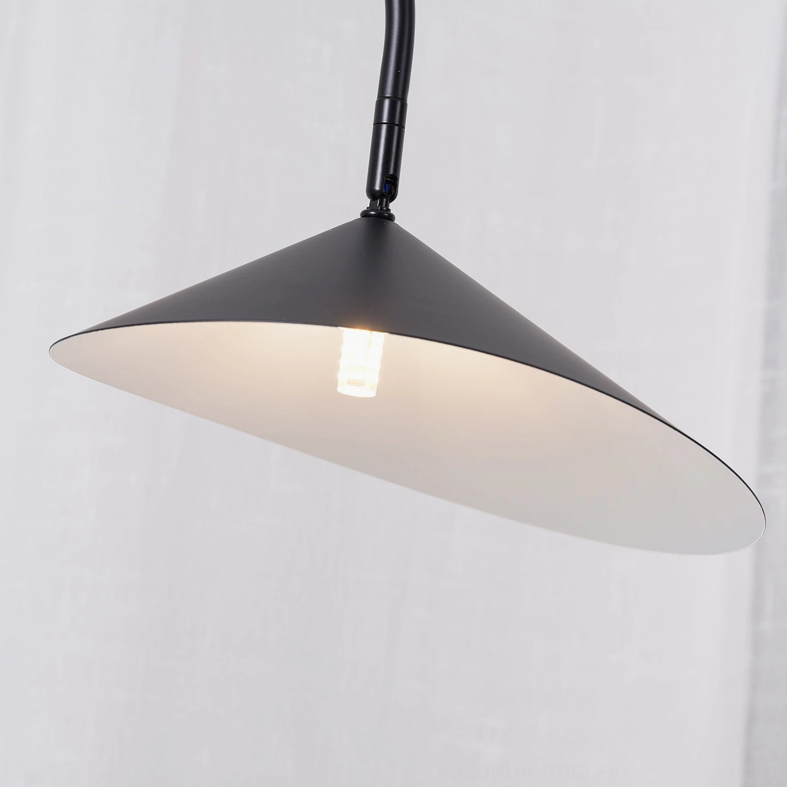 Beige sculptural Mono lamp with arched metal stem and natural cavestone marble base