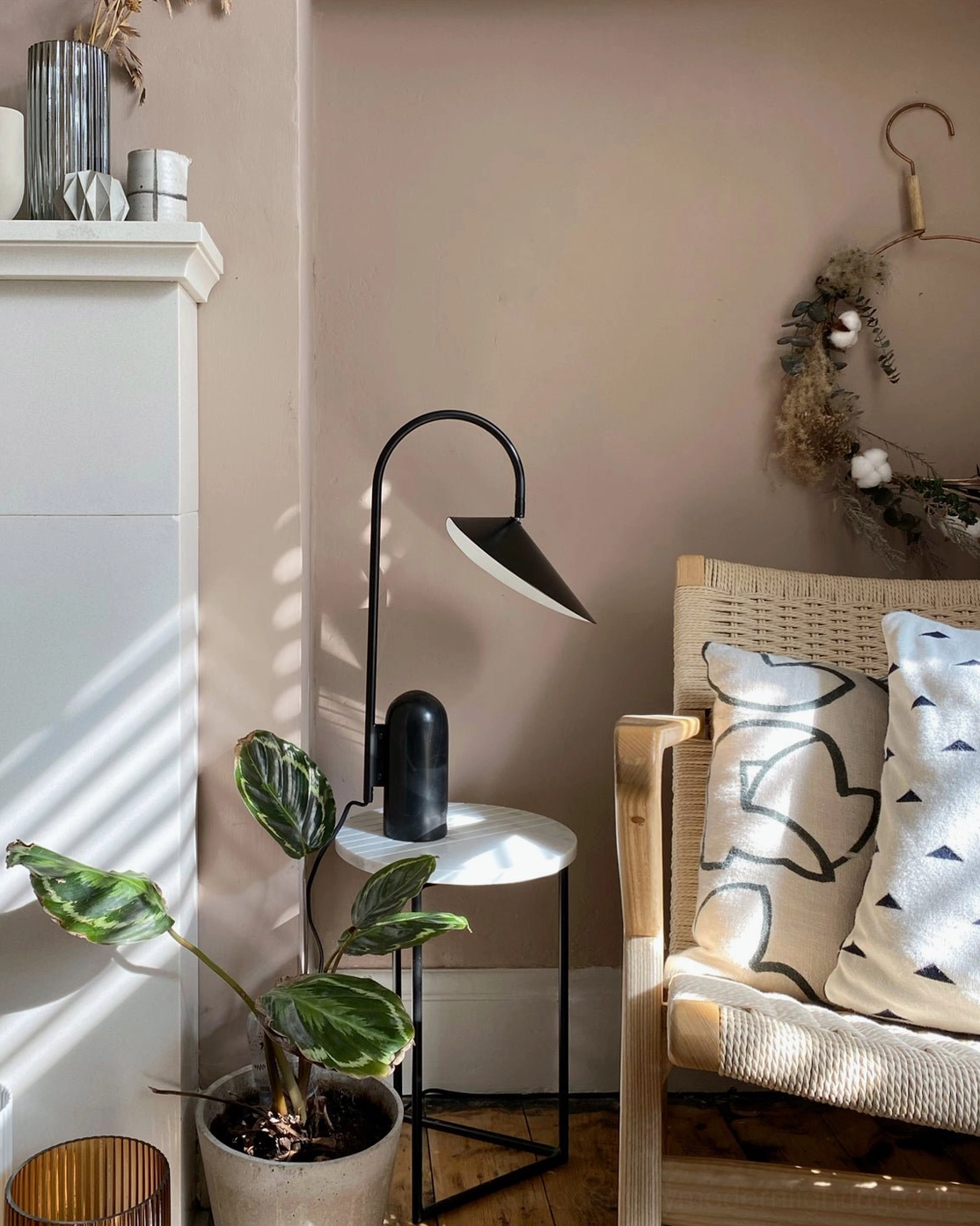 Black arch table lamp with sculptural form and marble base for modern home lighting design