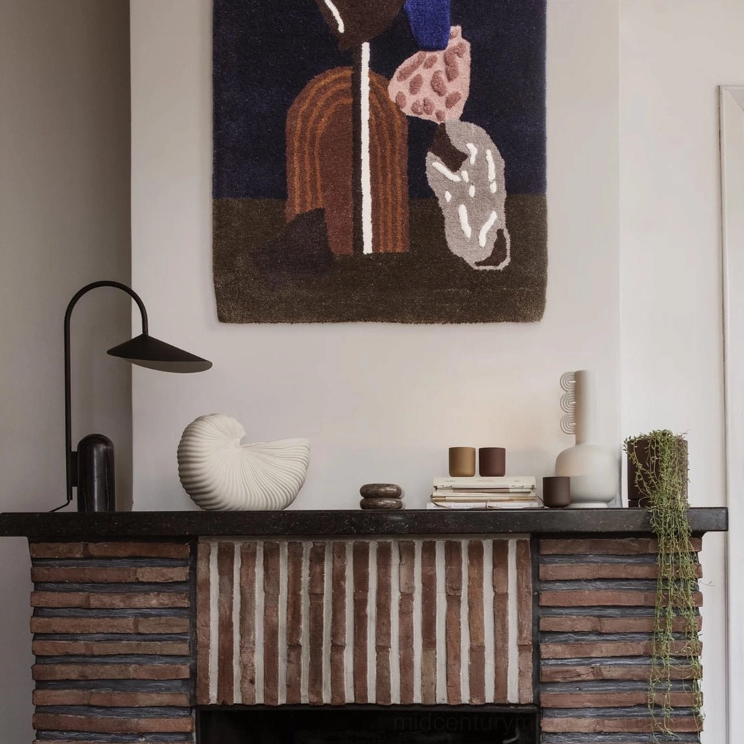 Contemporary black Mono lamp with natural travertine-style marble base in minimalist setting