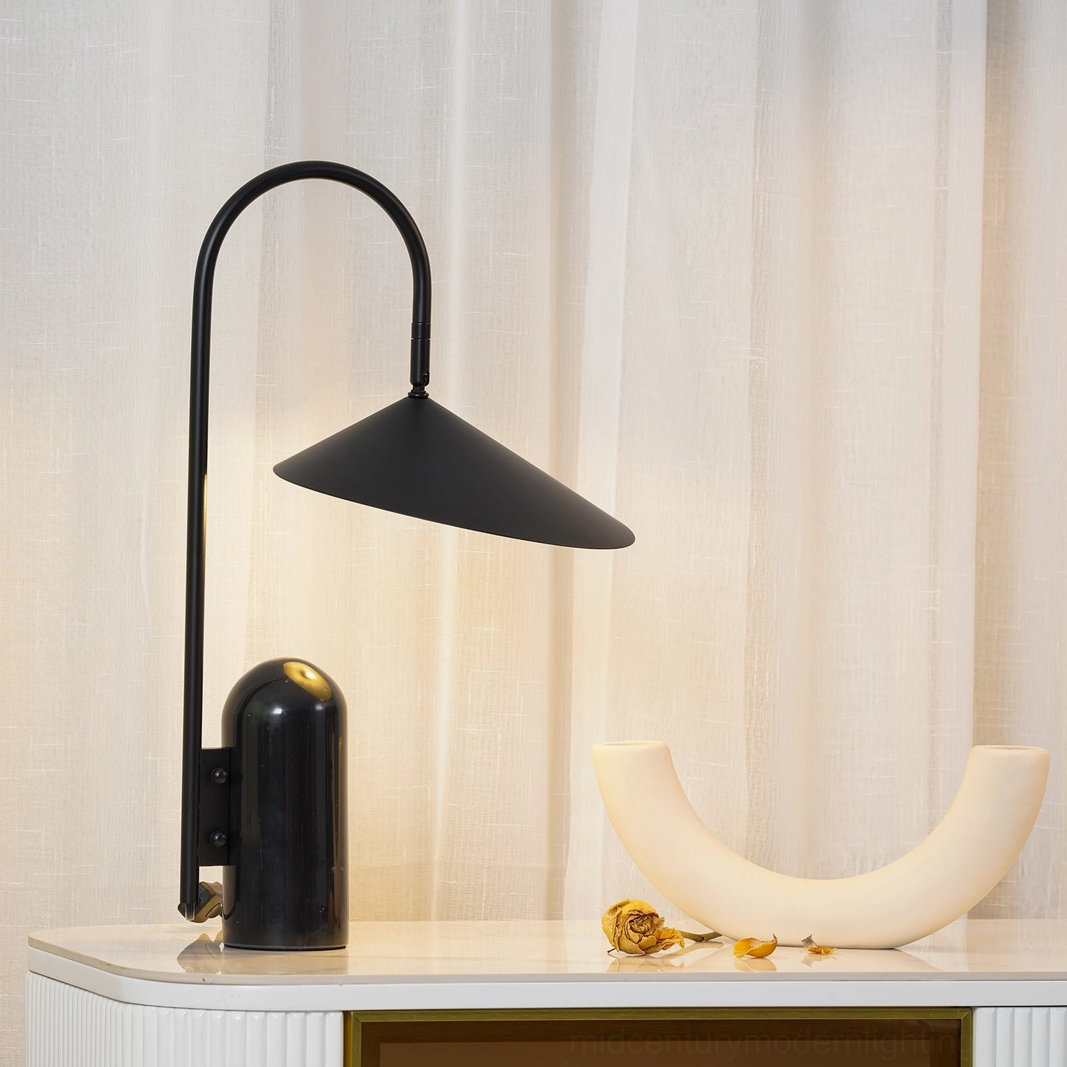 Black Mono table lamp with G9 socket shade positioned on minimalist desk workspace