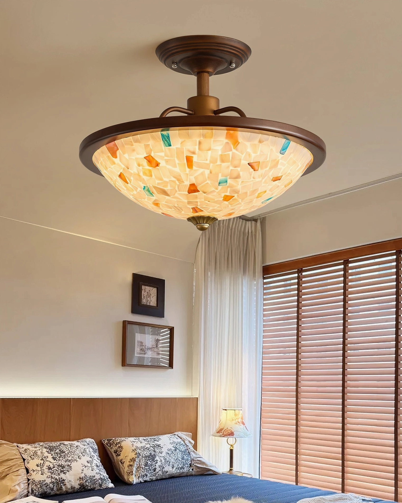 Monterey Capiz shell ceiling fixture installed in modern bedroom with warm ambient lighting and vintage-inspired decor