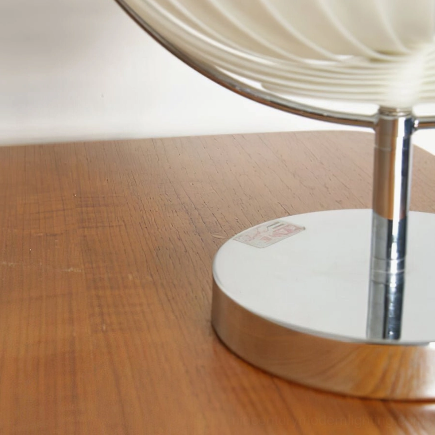 Moon Kare table lamp showing spherical pleated shade articulation and adjustable positioning capability