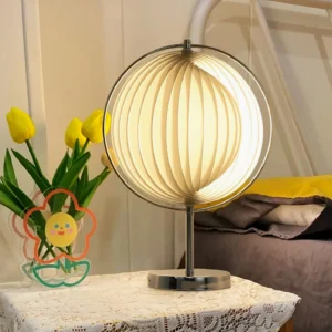 Moon Kare pleated globe table lamp positioned on bedroom bedside table with warm lighting and tulip flower decoration
