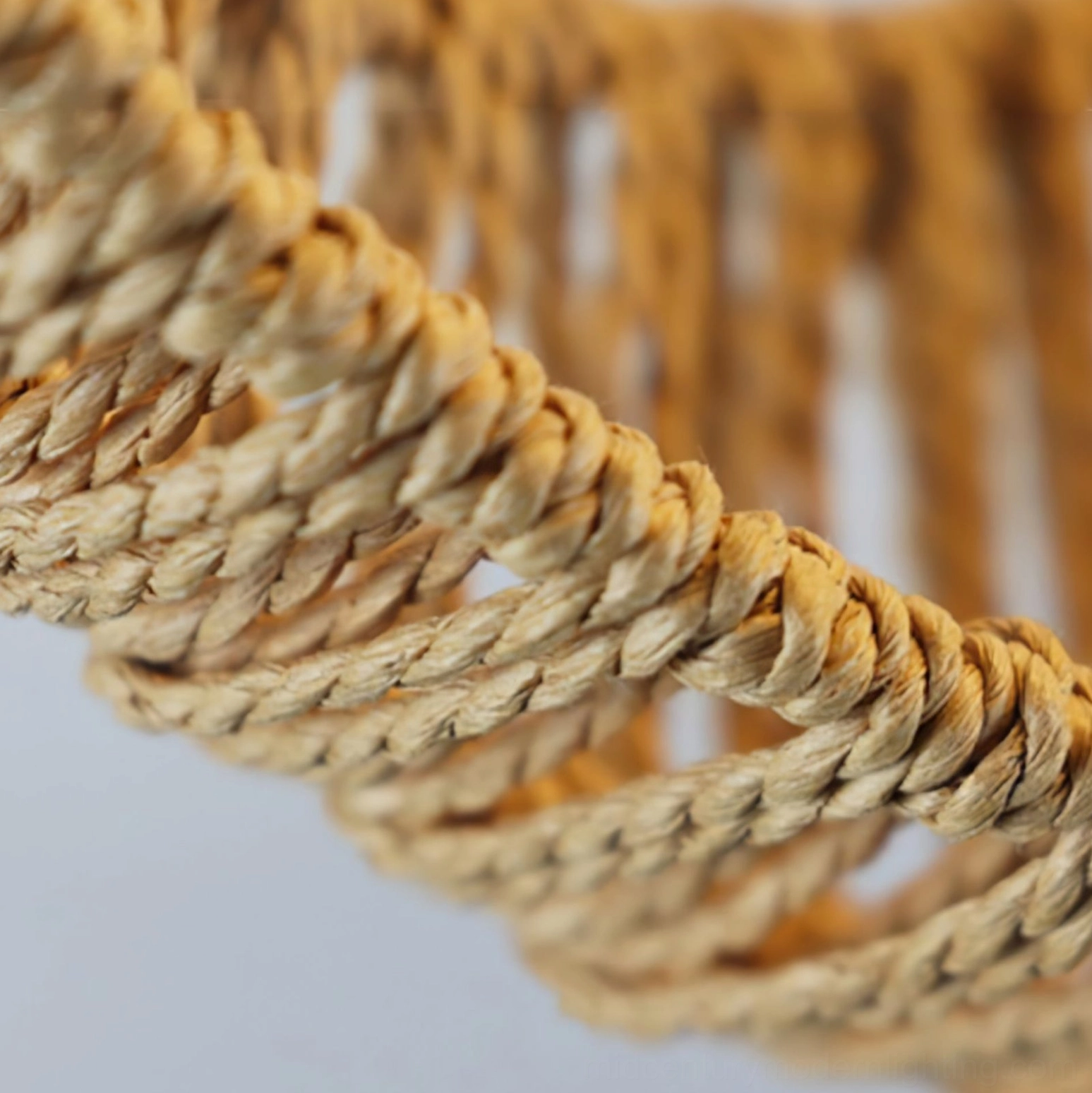 Side view of crescent moon frame showing tightly twisted hemp rope construction and metal armature support