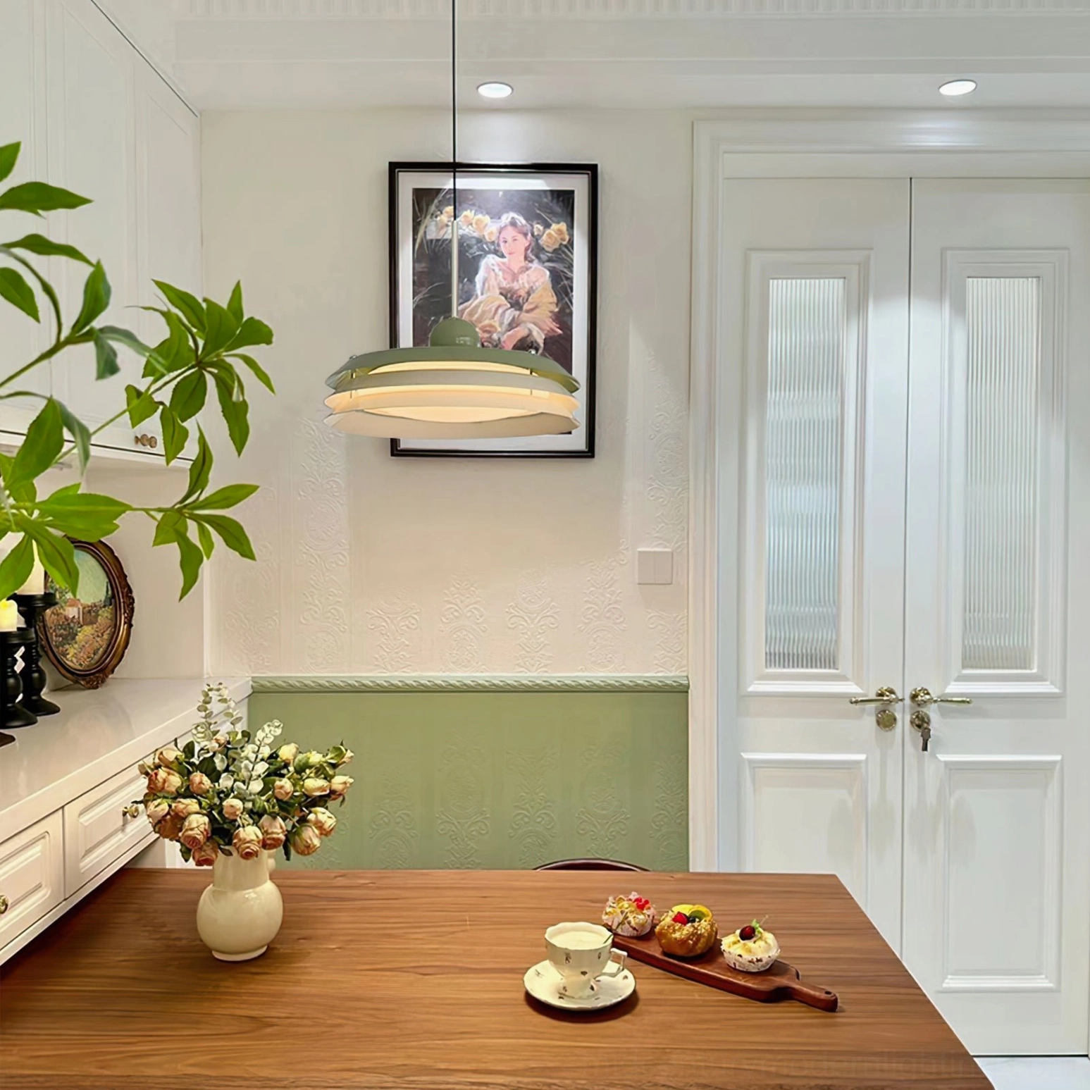 Green and white Morandi pendant lamp hanging in French country dining room with vintage décor