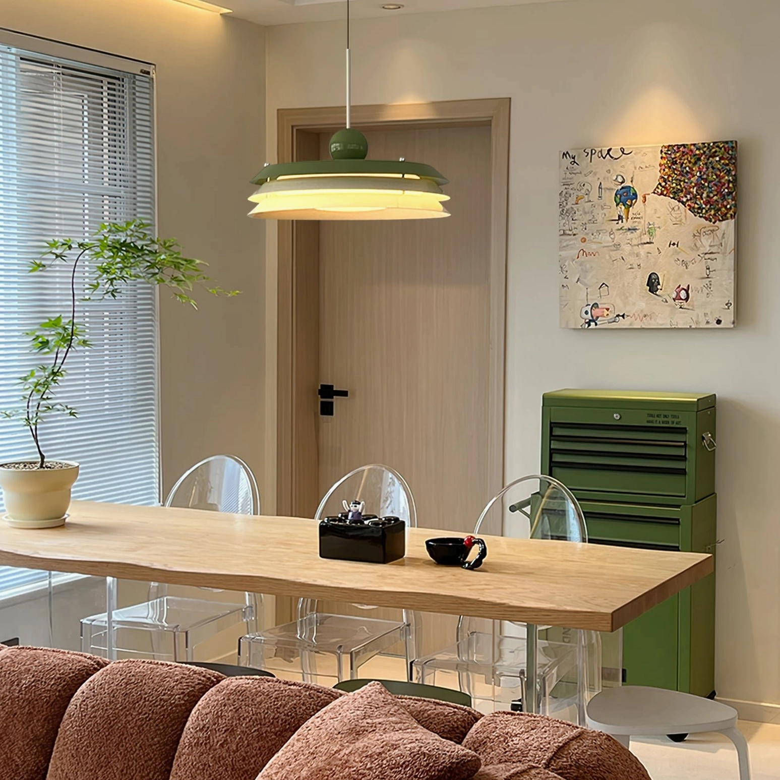 Morandi pendant lamp with green and white ceramic layers in modern minimalist dining space