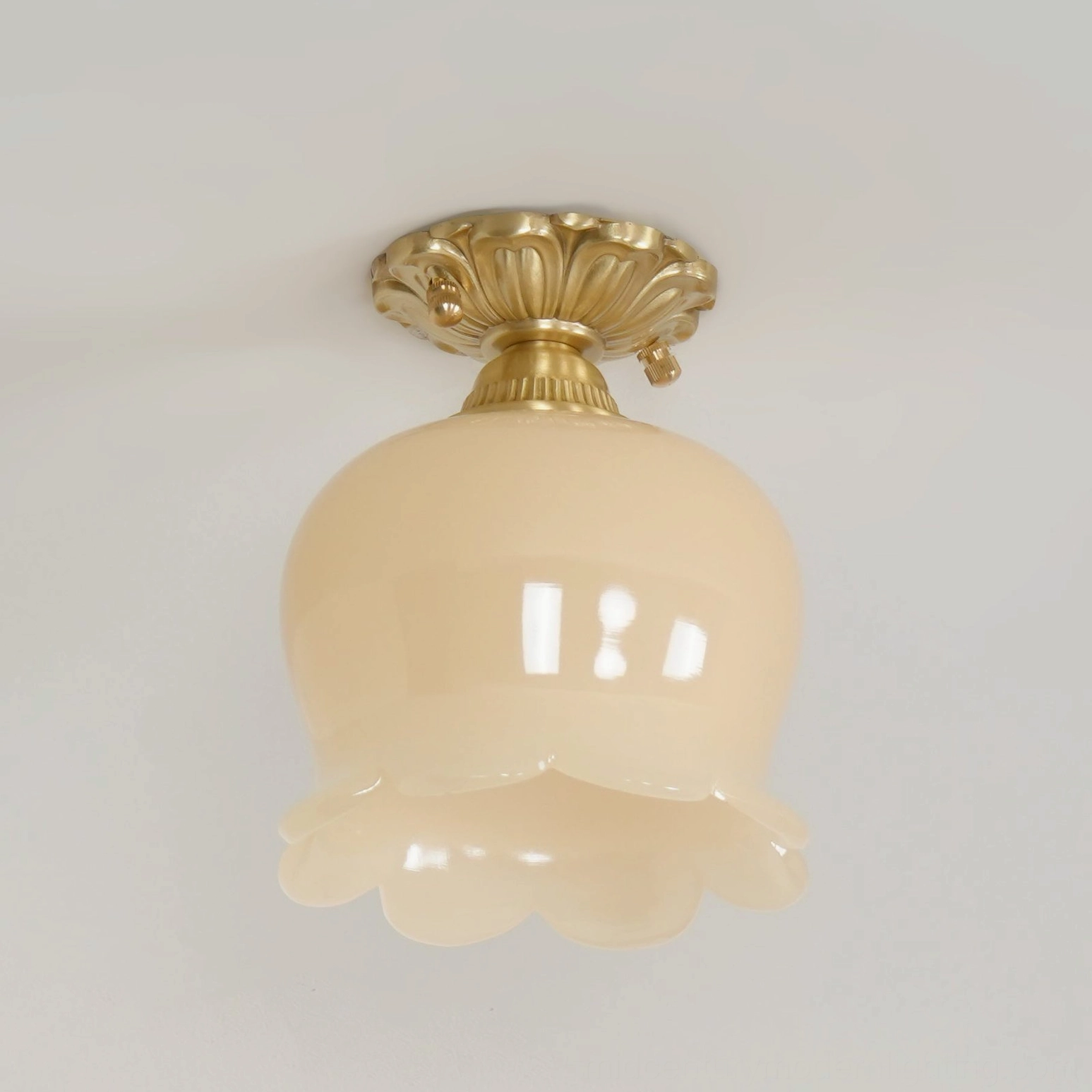 Morup tulip flush mount ceiling light in hallway with warm beige resin glow and brass fixture