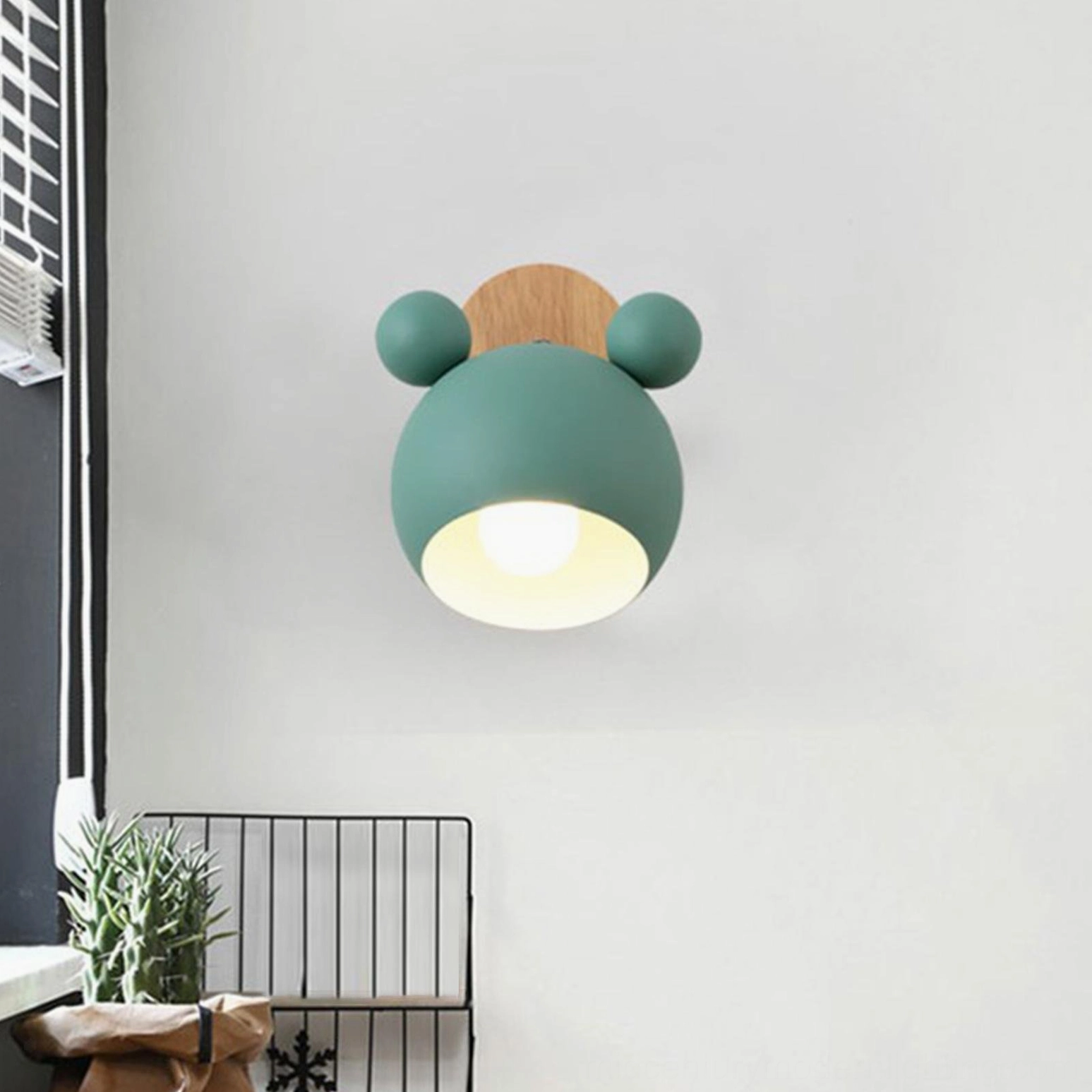 Minimalist Scandinavian mouse wall lamp creating focused reading light in bedroom nook