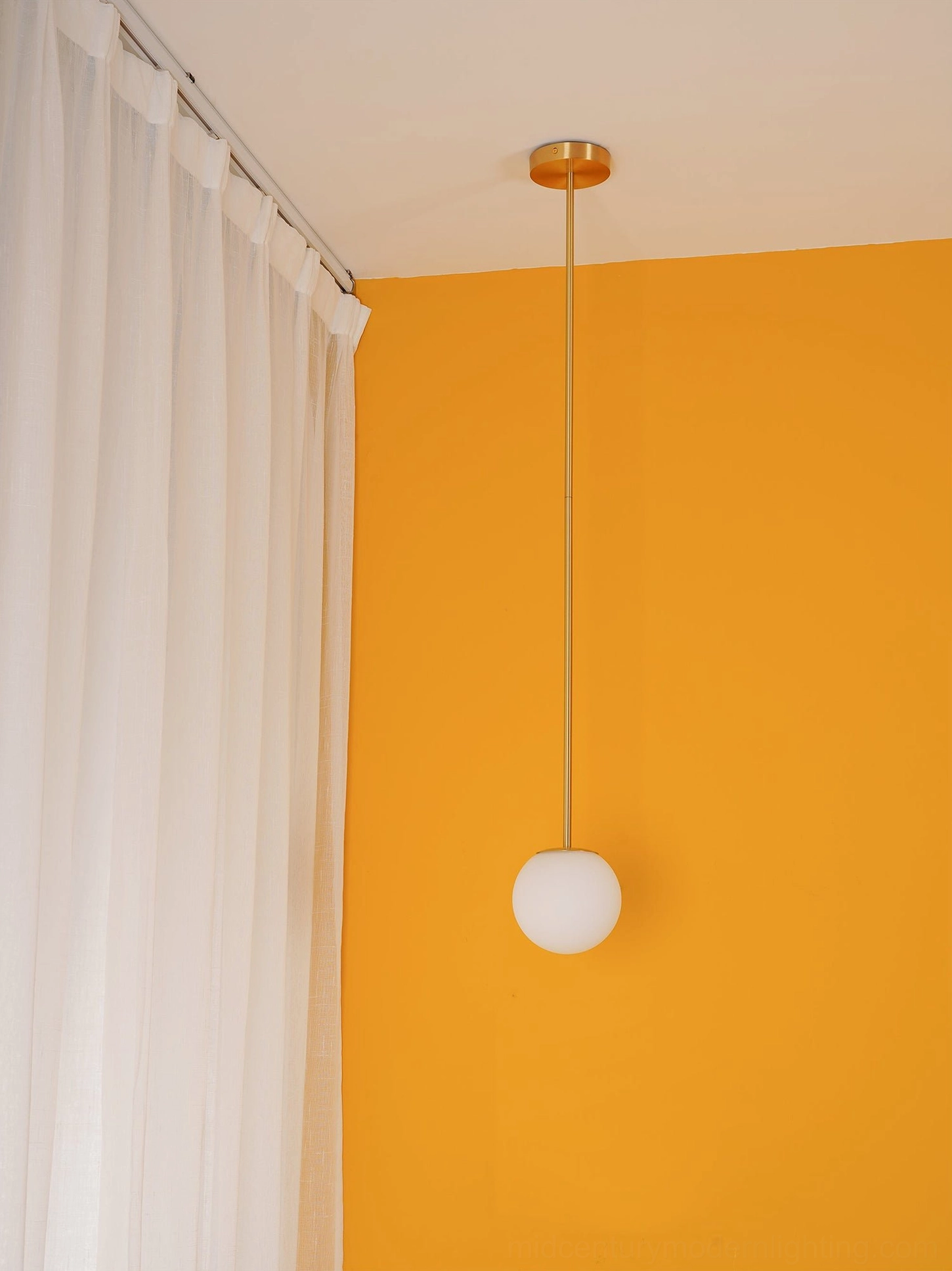 Artisanal mouth-blown glass globe pendant light demonstrating craftsmanship and diffusion
