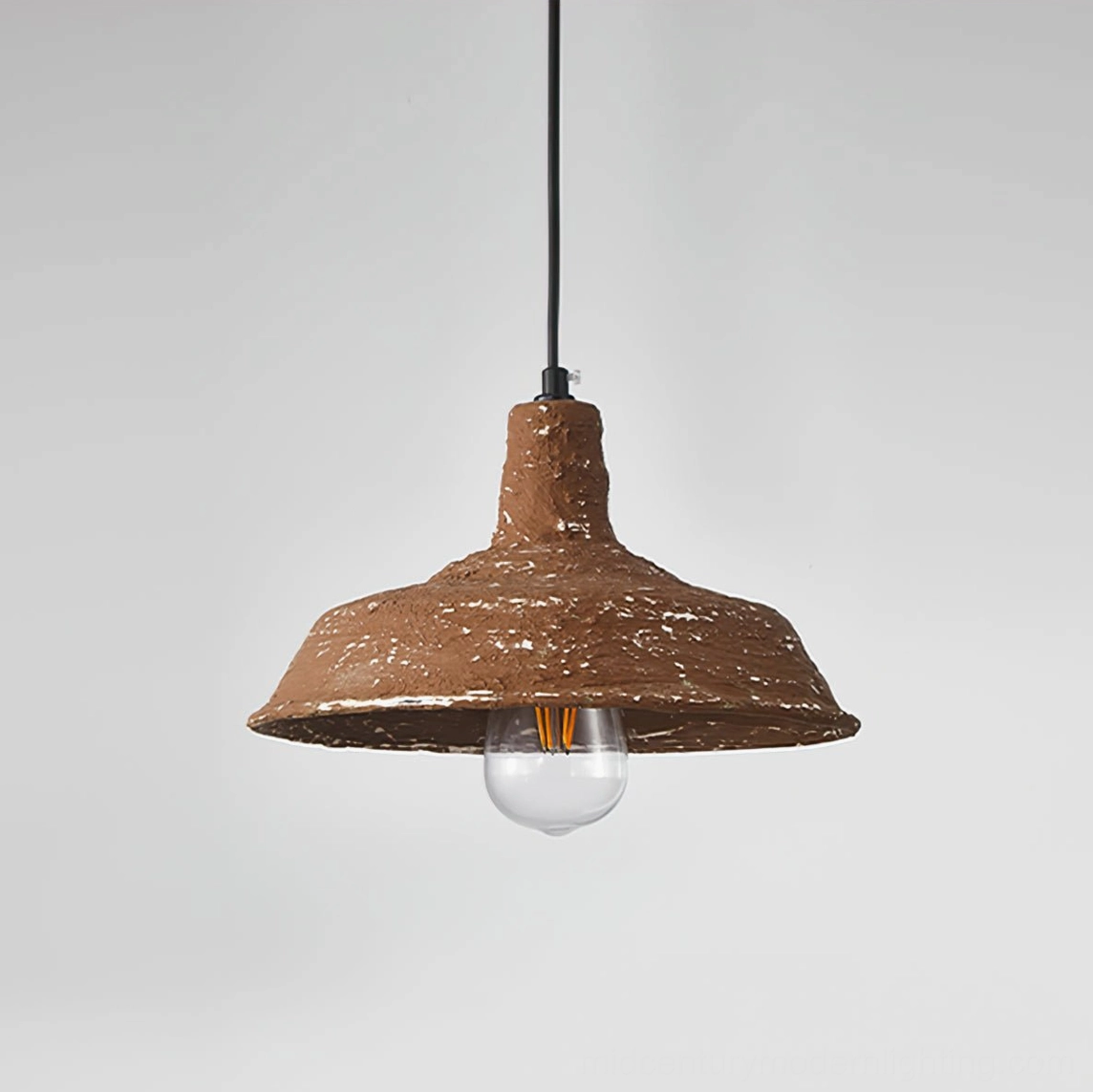 Mulino hand-finished pendant light with black cord and clear exposed bulb against white background