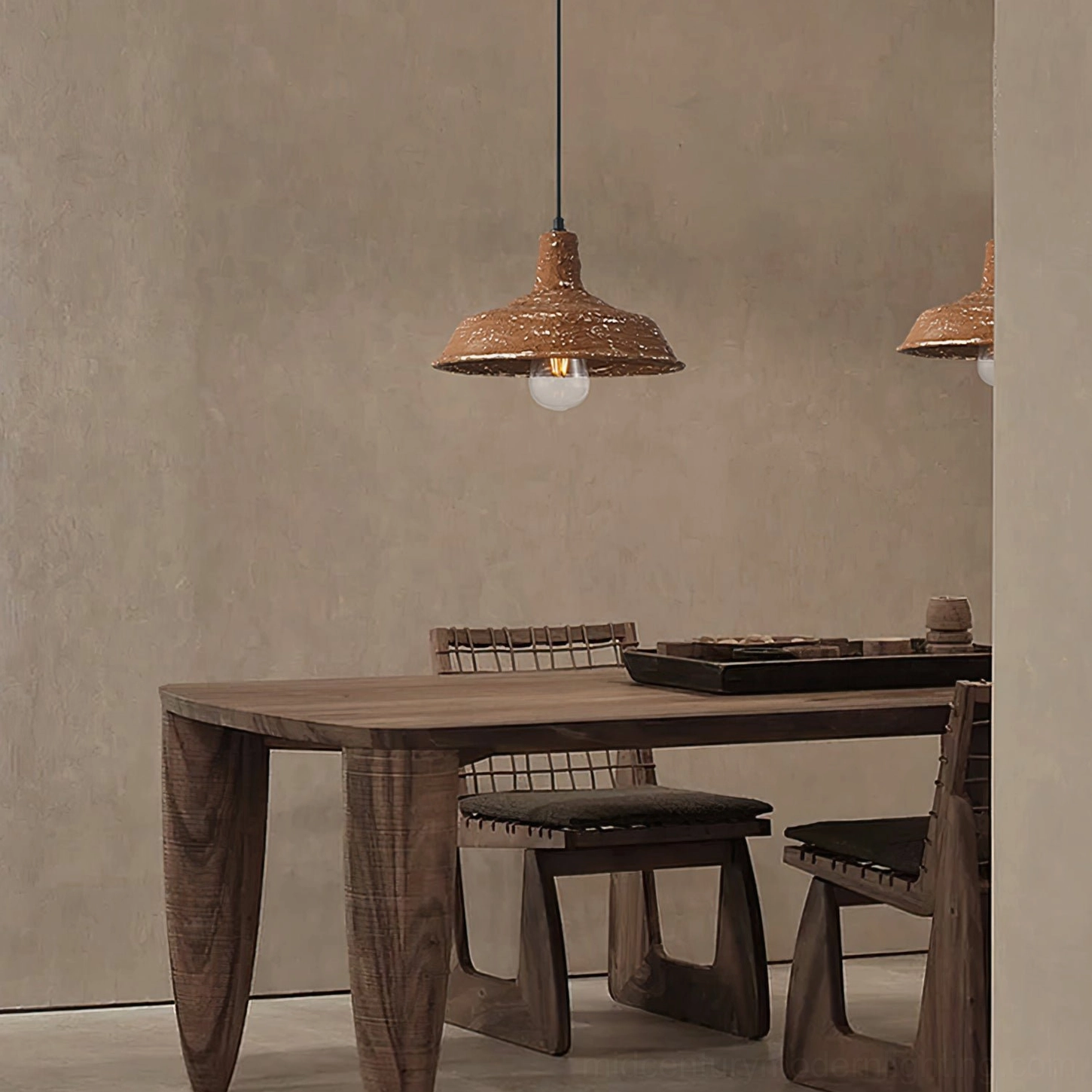 Mulino hand-finished pendant lamp pair suspended over rustic wooden dining table with warm glowing light