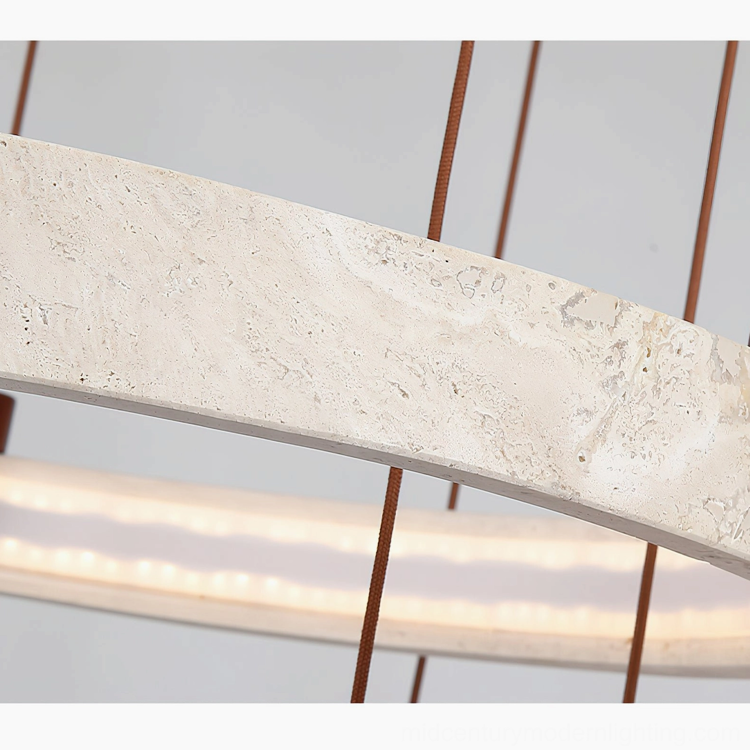 Multi-ring travertine chandelier installation view showing varied heights and sculptural composition in modern space