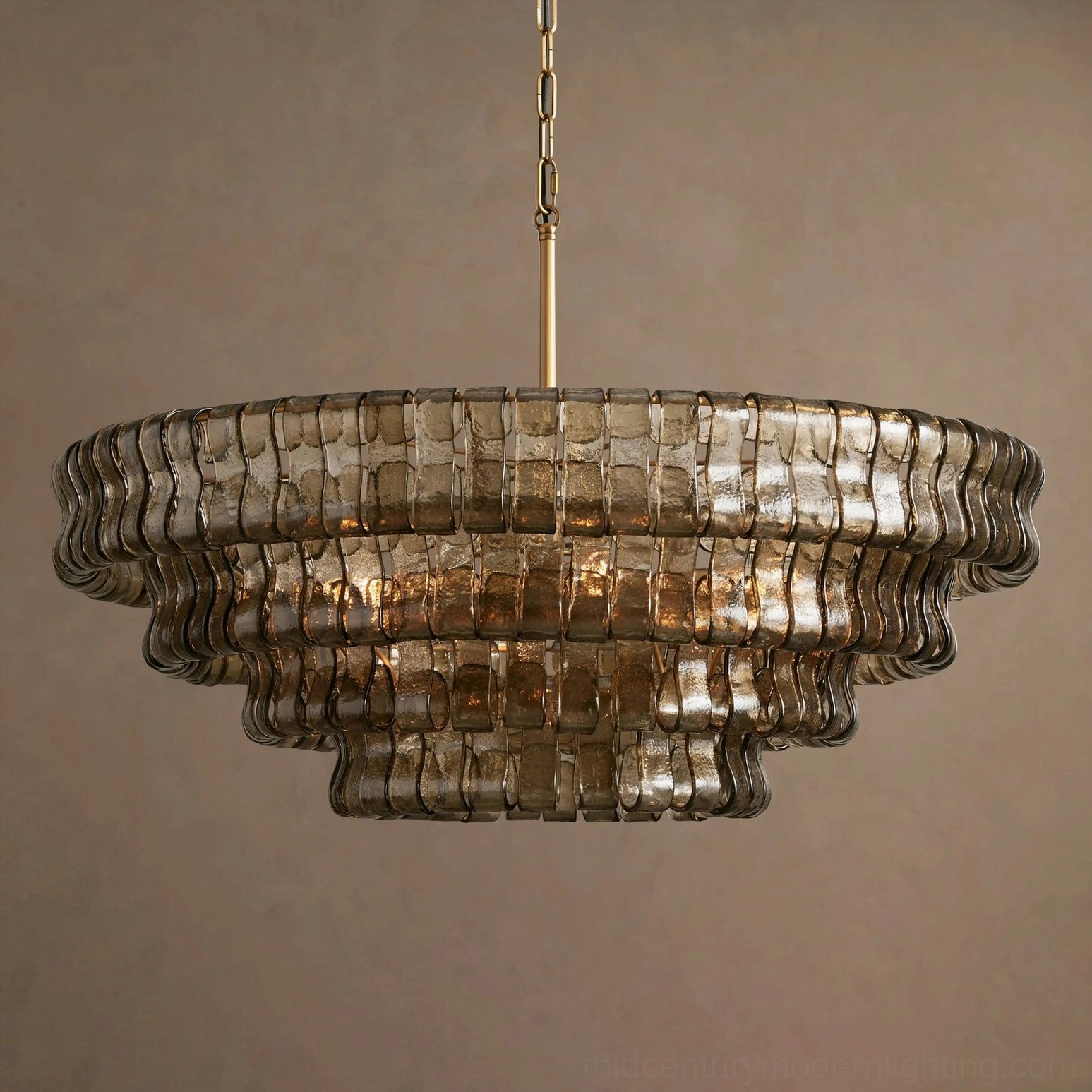 Multi-tiered round chandelier fixture, ice-textured glass layers creating prismatic light effects, architectural detail