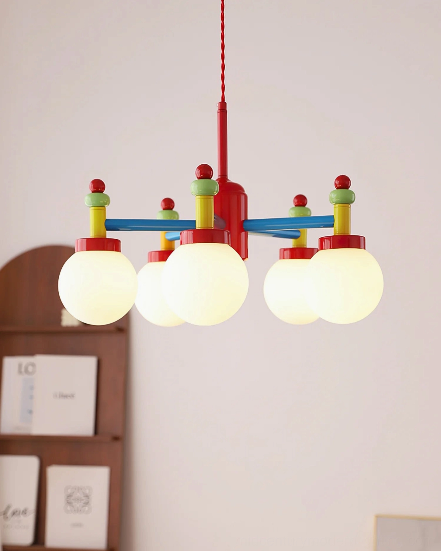 Front view of illuminated multihead pendant light with all bulbs lit and uniform color design