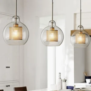 Three hanging glass pendant lights suspended above modern kitchen dining table