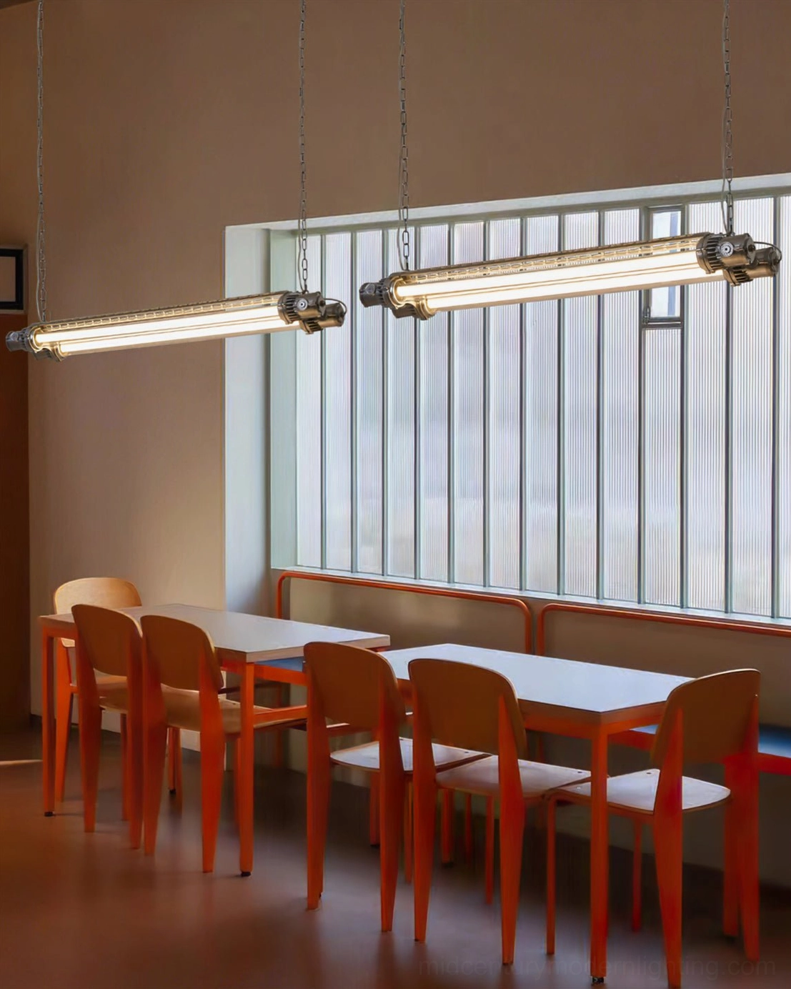 Multiple silver tube chandeliers installed in casual dining restaurant, uniform industrial pendant lighting fixtures