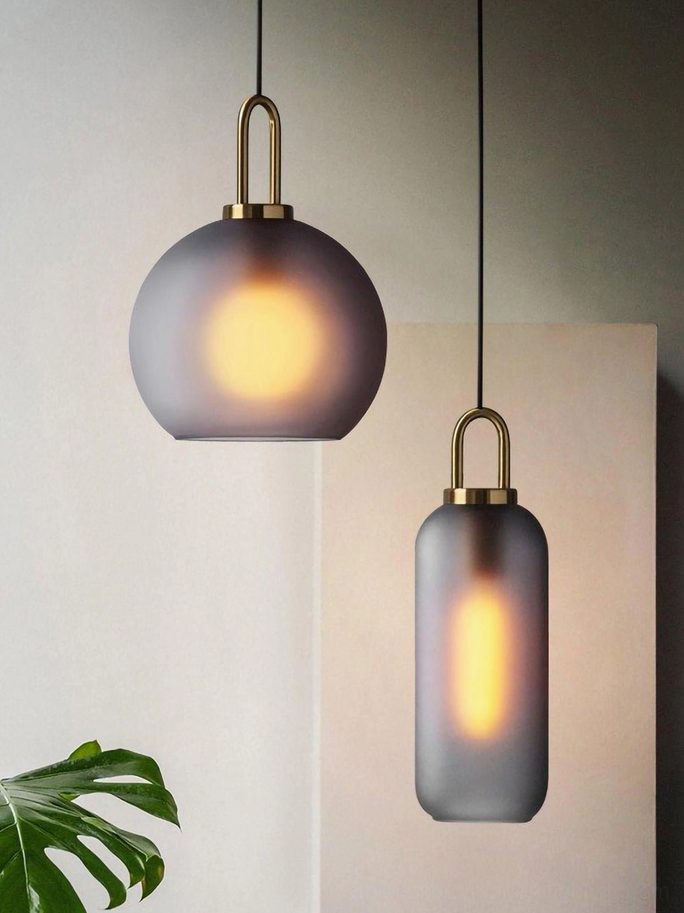 Multiple size options of spherical smoked glass pendants showing mid-century modern versatility