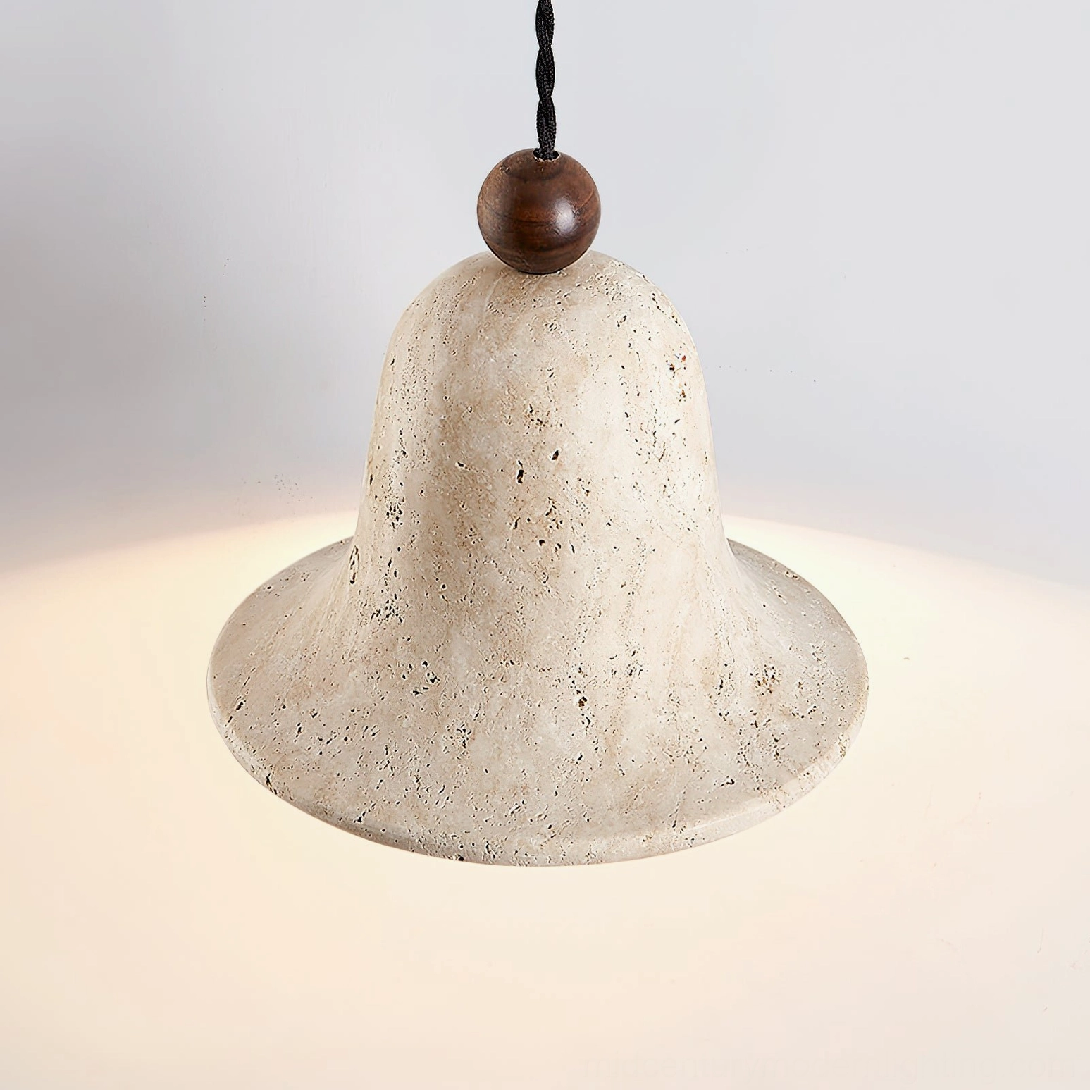 Multiple travertine bell pendants clustered arrangement showing design versatility and spatial rhythm