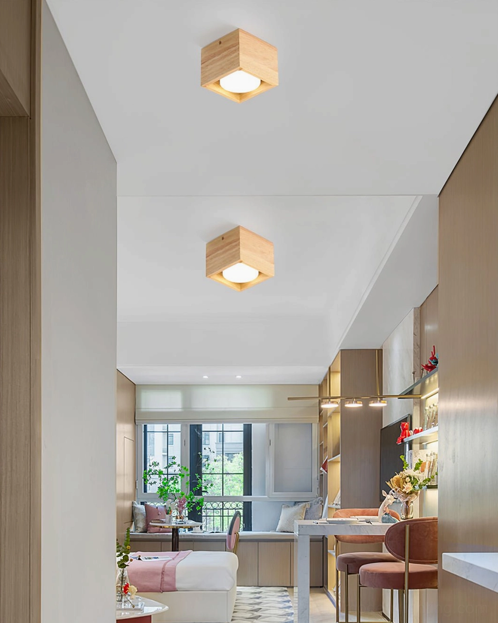 Multiple solid wood ceiling lamps in open-concept japandi apartment with dining nook, coordinated wood-tone lighting