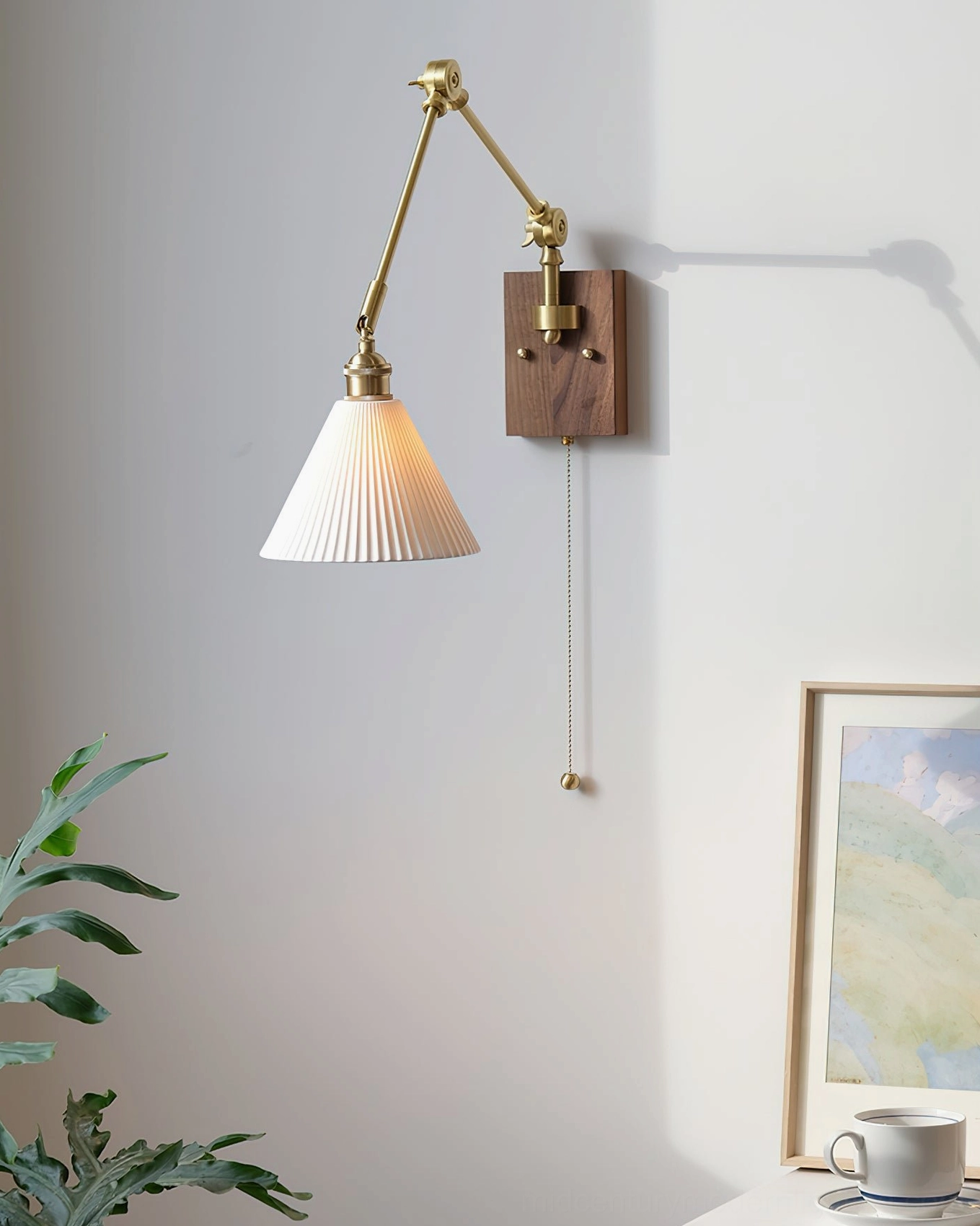 Murale swing arm wall lamp mounted beside potted plant in mid-century modern living room corner with geometric styling