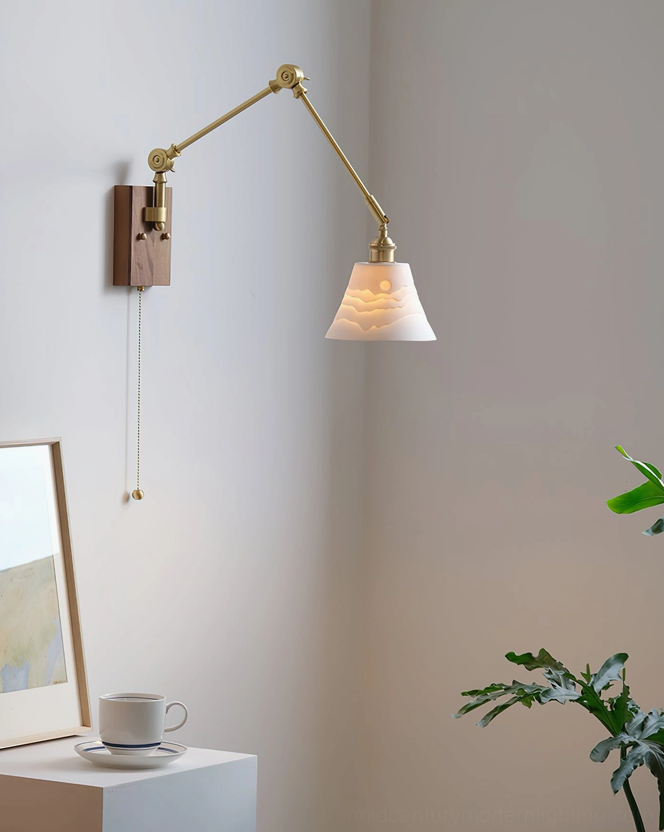 Murale wall-mounted swing lamp with textured fabric shade, pull chain zipper switch visible, framed artwork backdrop