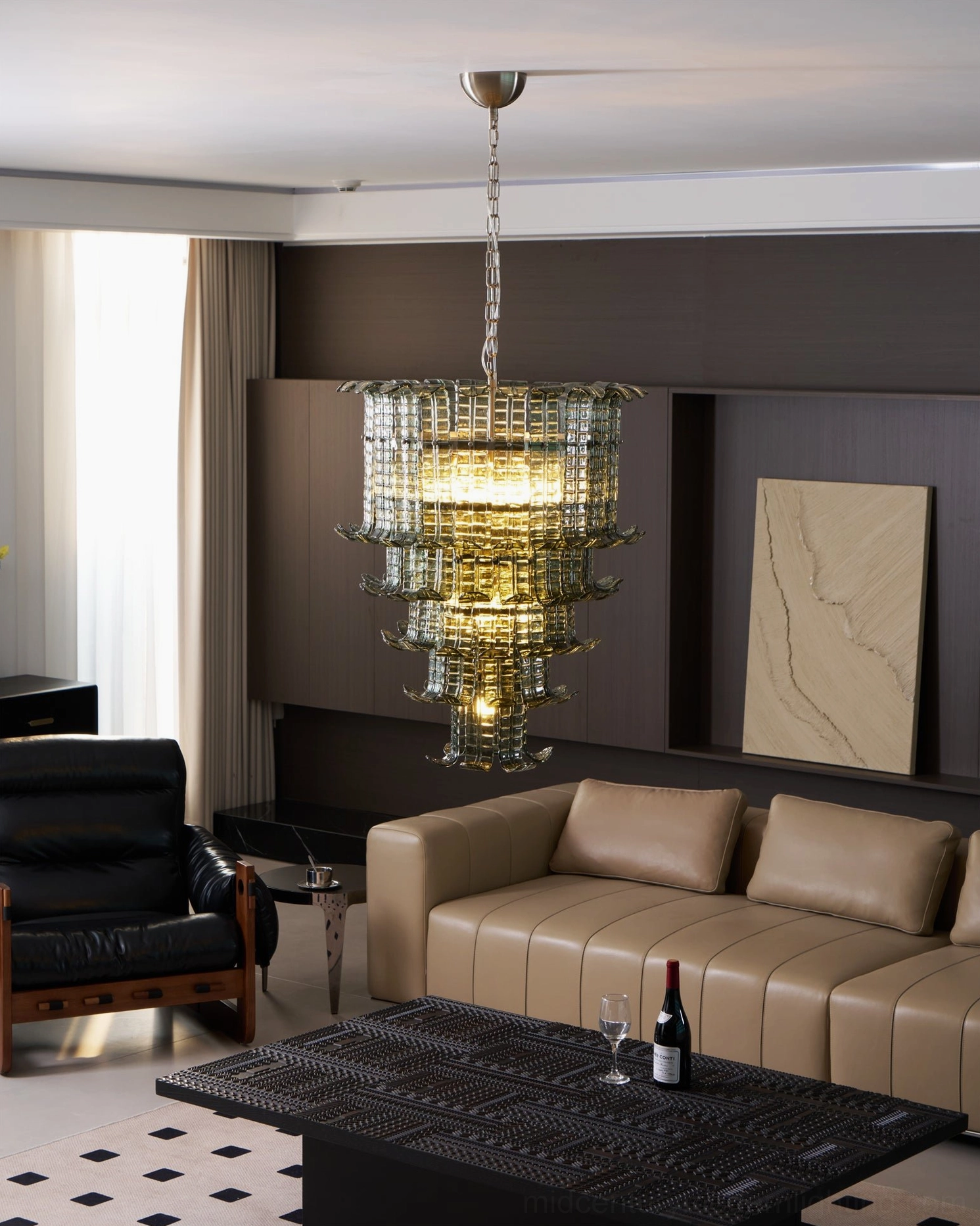 Glowing murano glass tiered chandelier casting warm yellow light in high-end modern residential living room central view