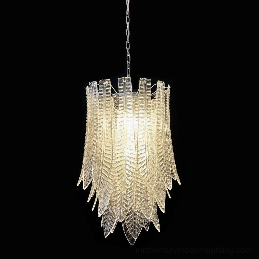 Illuminated Murano glass chandelier overhead view with warm glow highlighting layered textured leaf glass design and multi-bulb configuration