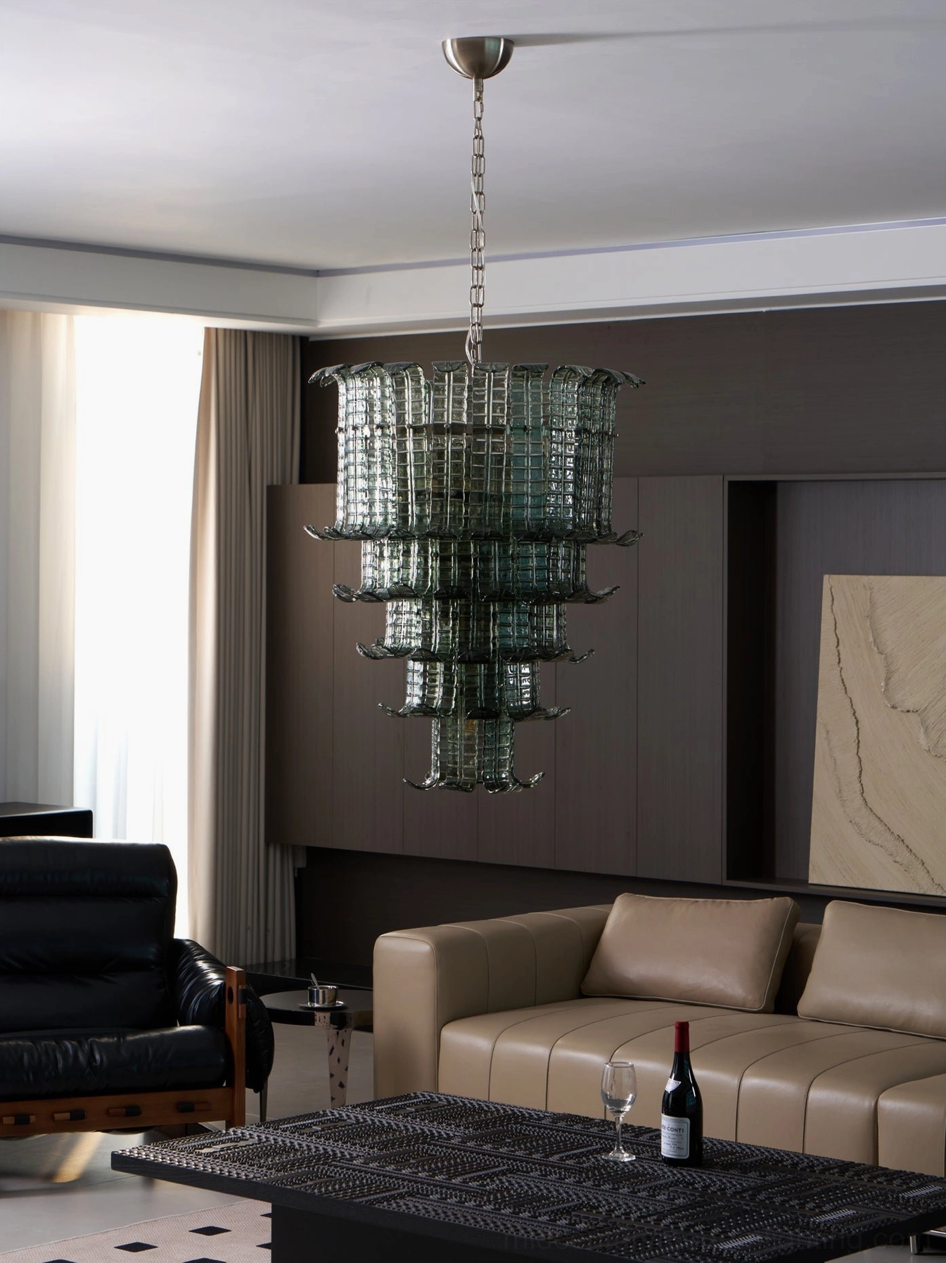 Murano tiered smoked glass chandelier side view in modern living room with neutral beige sofa, showcasing layered glass design