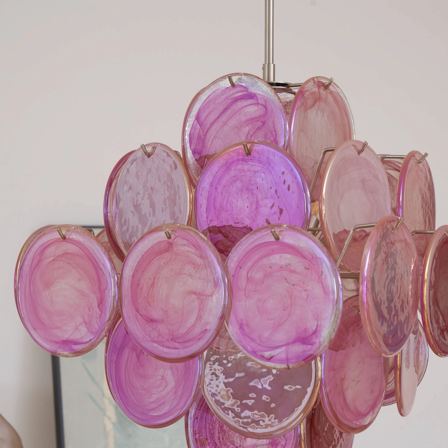 Purple-pink gradient disc chandelier in indoor wall decor setting showing color variation and atmospheric lighting
