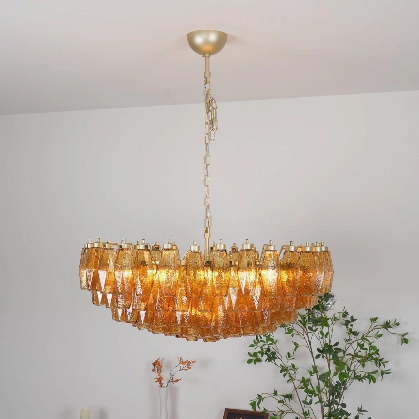 Rhombus Murano chandelier showing architectural form with metal frame and warm amber light transmission