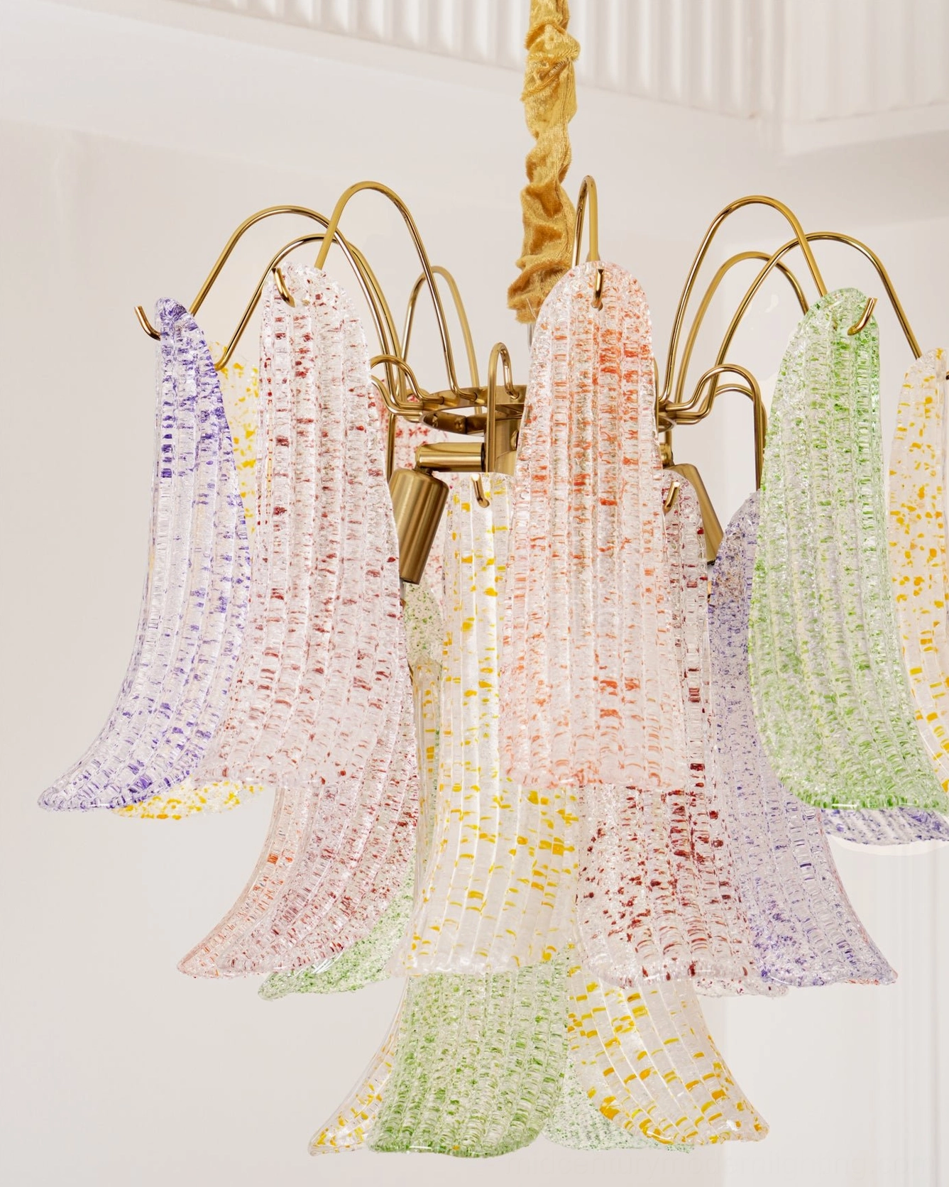 Close-up of Murano glass chandelier showing brass armature and powder-coated metal frame construction