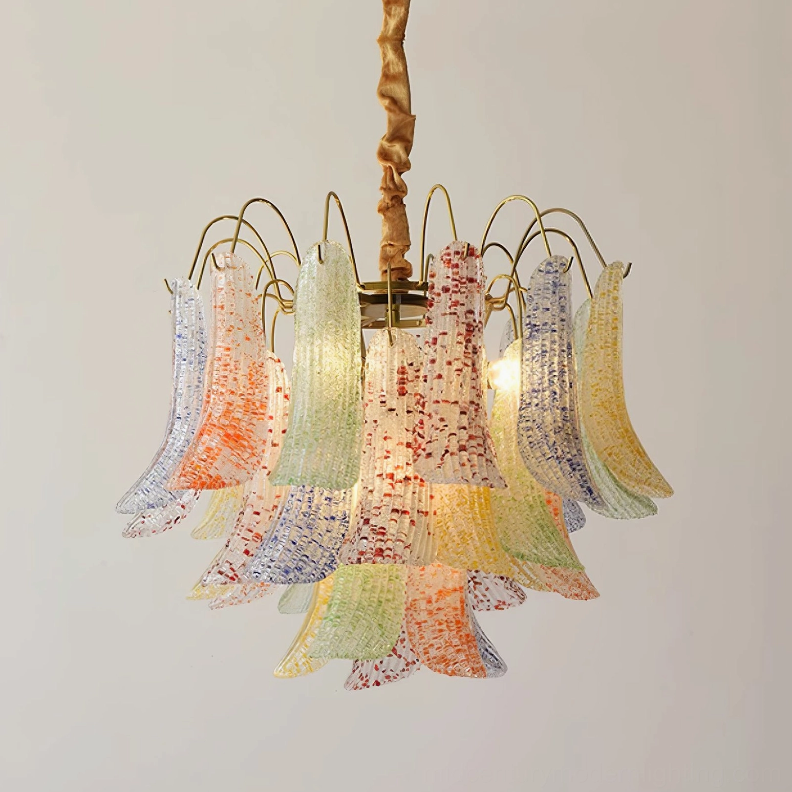 Low angle detail of Murano glass chandelier showing pastel speckled flared glass shades with twisted brass rod