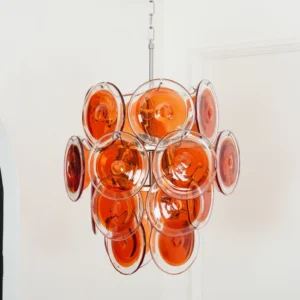 Low-angle view of amber Murano glass layered chandelier chrome rod suspension