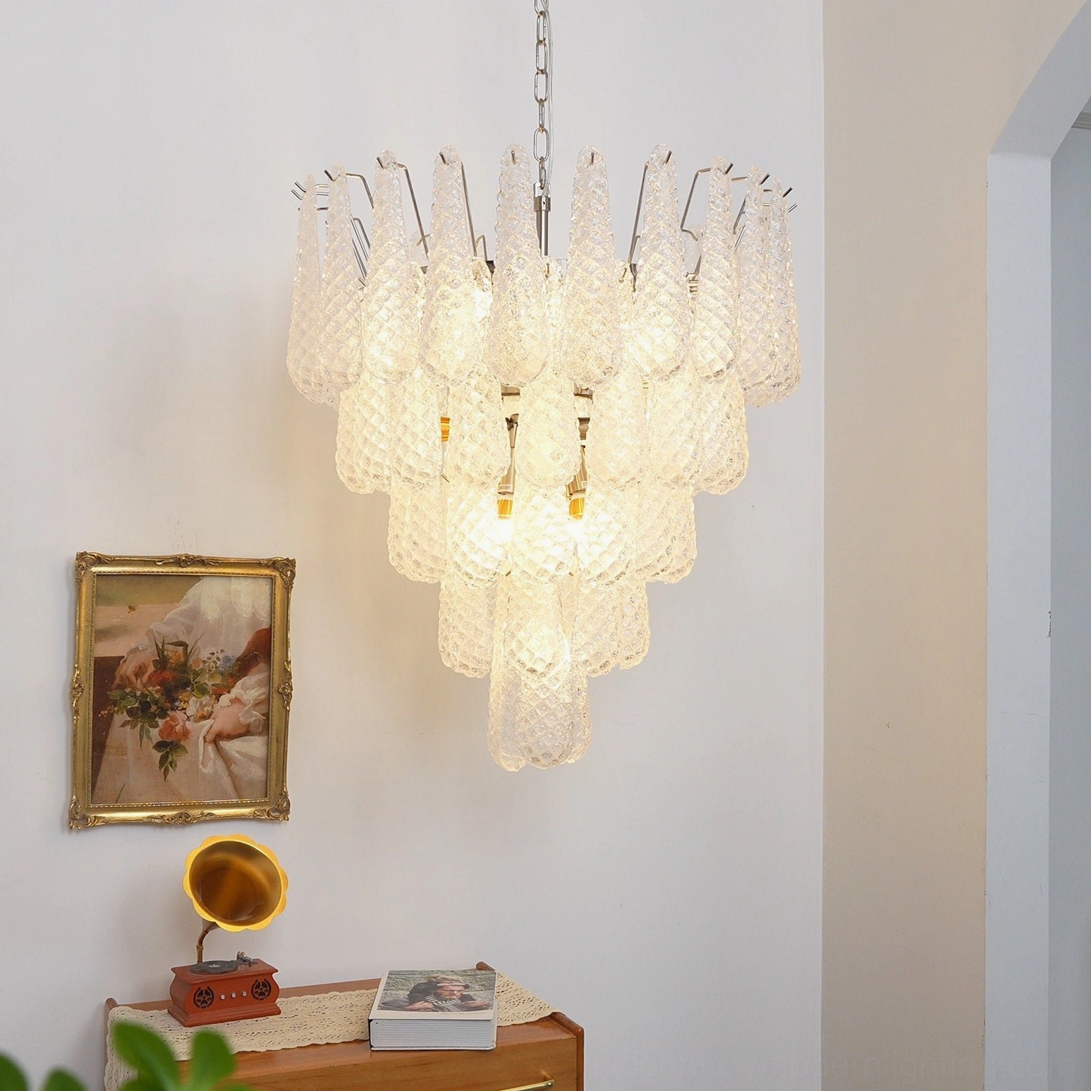 Venetian Murano glass chandelier with cascading clear glass droplets, warm glowing ambient lighting in vintage residential setting