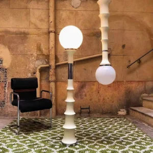 Pair of matching globular floor lamps in mid-century modern interior with vintage industrial aesthetic and green patterned rug