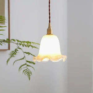 Murano glass pendant light installed in cozy living corner with vintage decor and warm ambient lighting