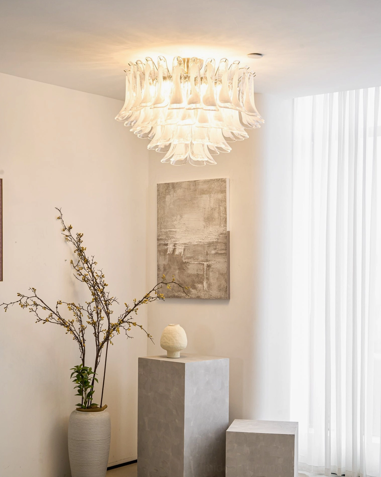 Illuminated Murano Petal chandelier in entryway, warm glowing light reflecting through hand-blown glass petals