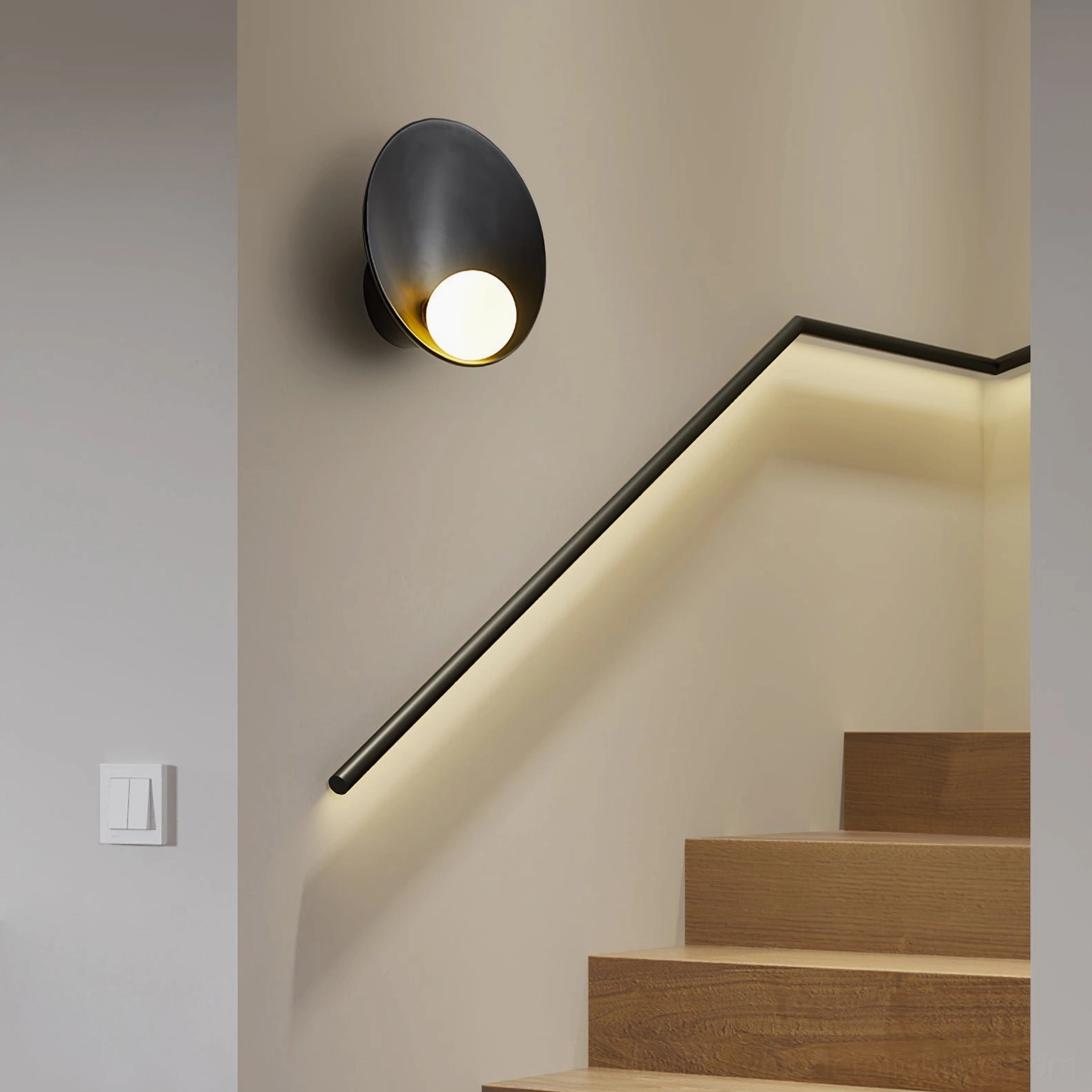 Musa black wall light with curved metal shade mounted on stairwell wall beside wooden steps