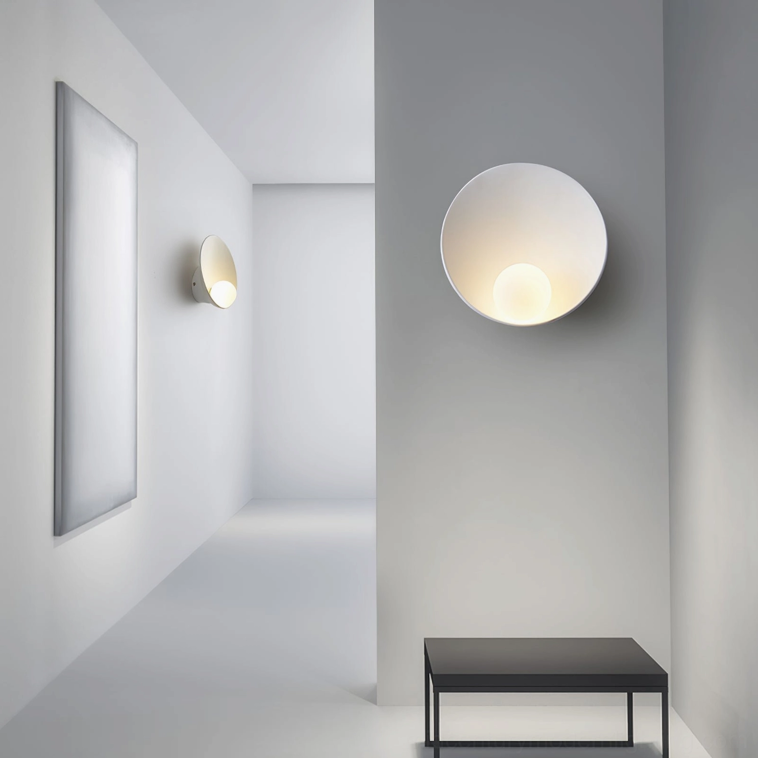 Pair of Musa minimalist wall lamps in long modern hallway creating symmetric warm lighting design