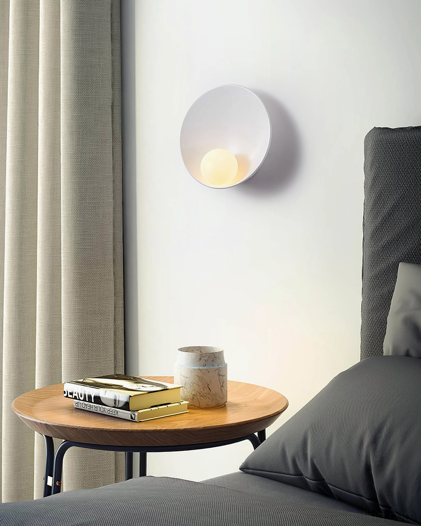 White Musa wall sconce mounted beside modern bedroom bedside table with matte finish accent