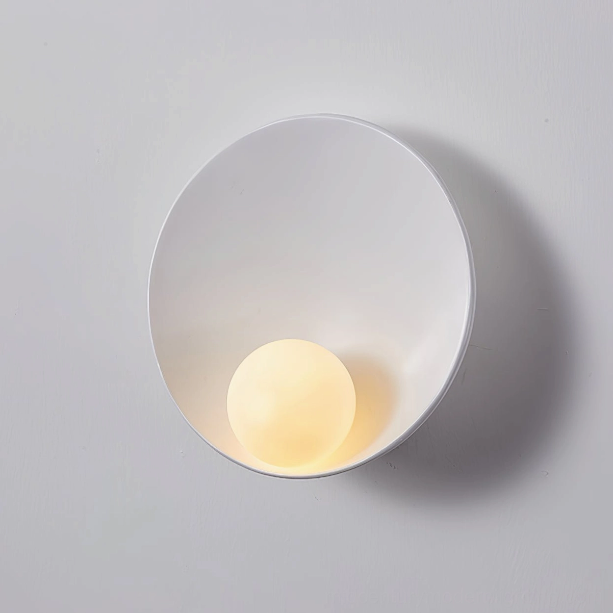 Pure white Musa wall lamp with crisp matte finish and frosted glass diffuser for warm glow