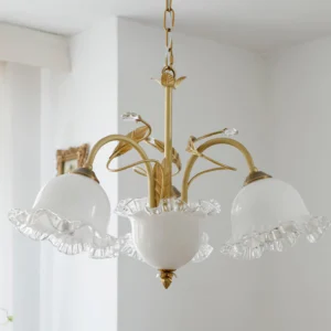 3-light Muse Flower Chandelier brass framework with ruffled glass shades installed in bright room