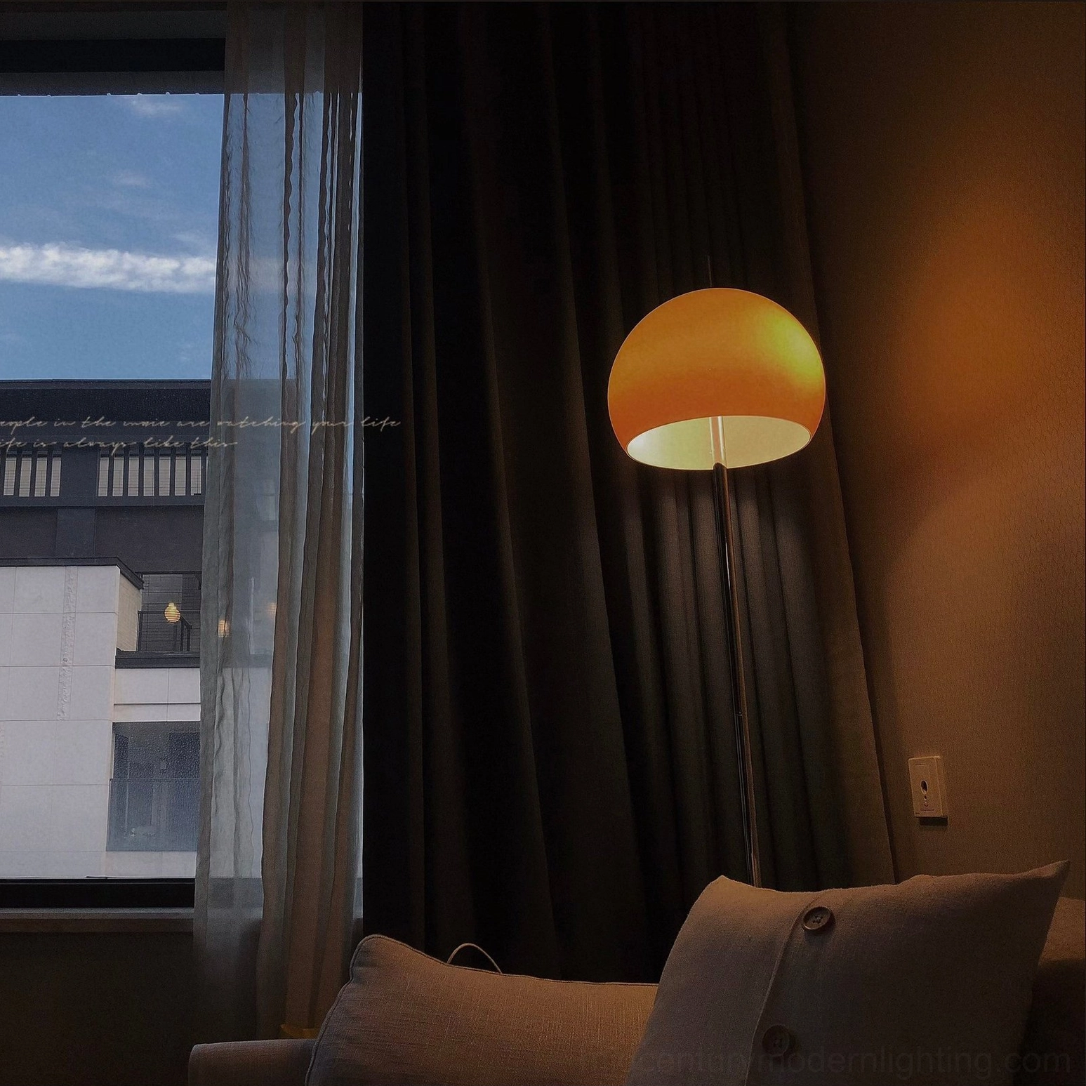 Low-angle view of mushroom floor lamp in nighttime bedroom corner with dark curtains and ambient mood
