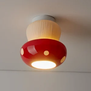 Overhead close-up of red mushroom flush mount light showing textured beige stem and glossy red cap details