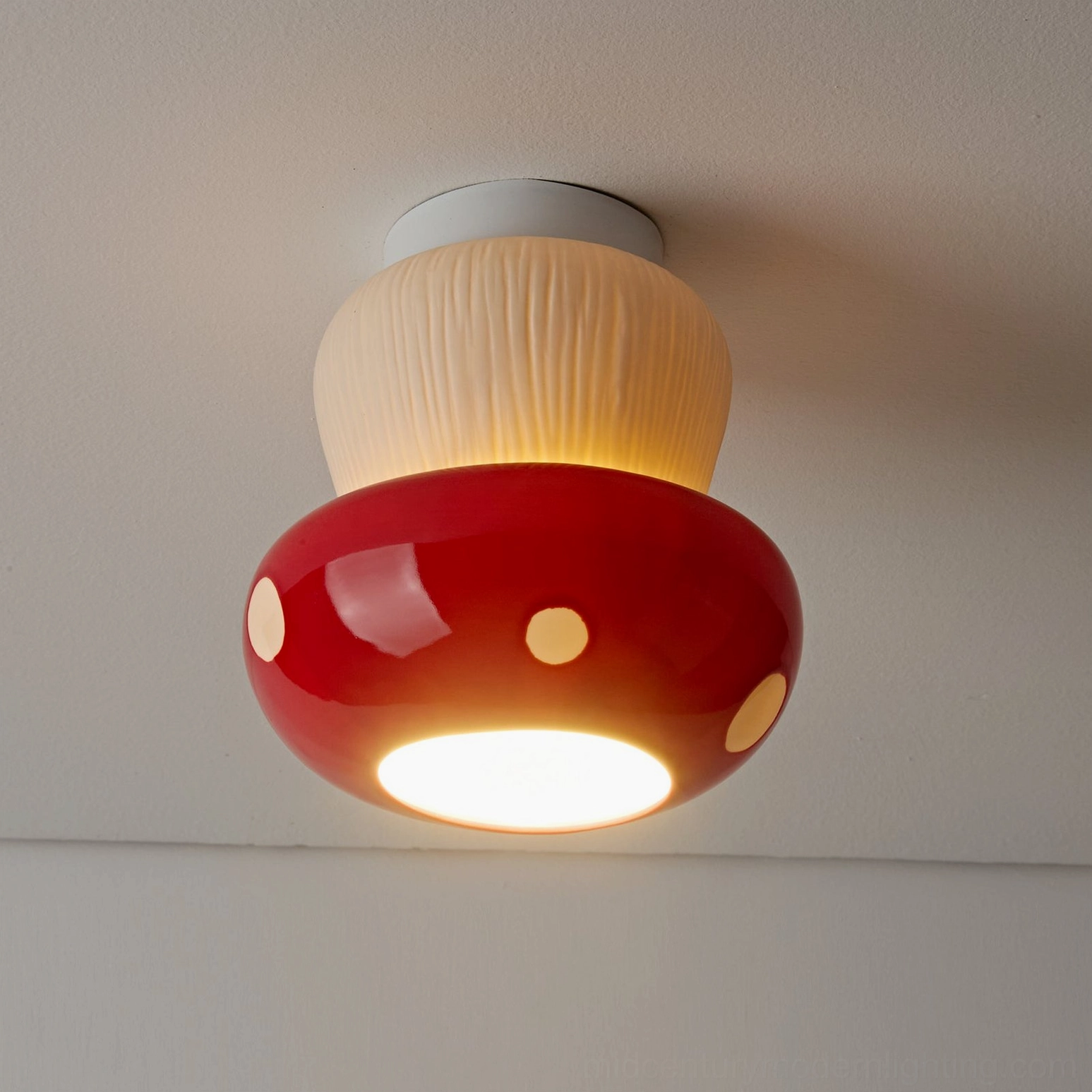 Overhead close-up of red mushroom flush mount light showing textured beige stem and glossy red cap details