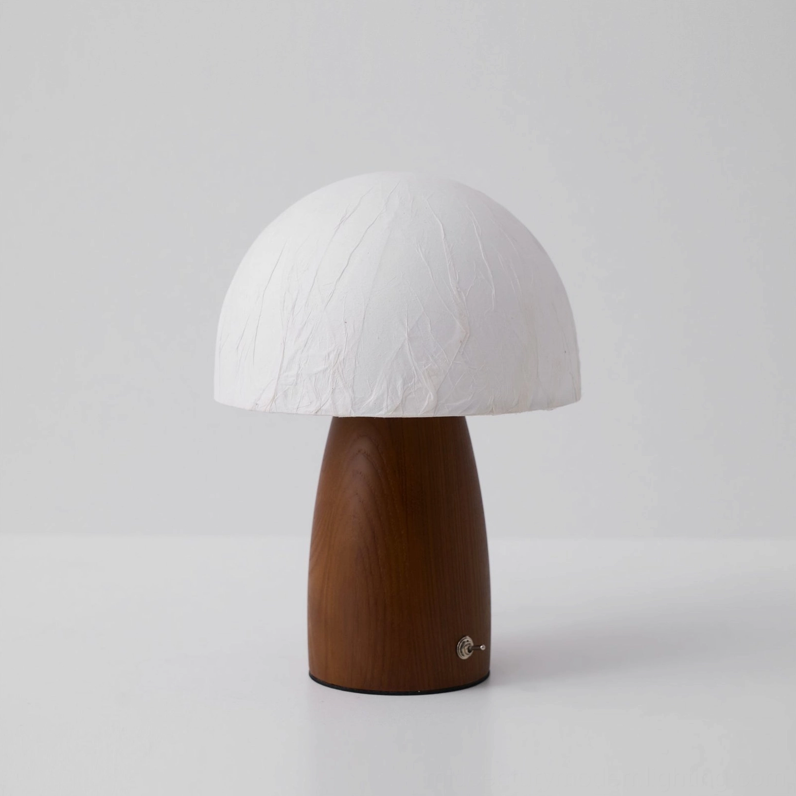 Mushroom table lamp side flat shot, unlit, matte off-white shade with dark brown solid wood base