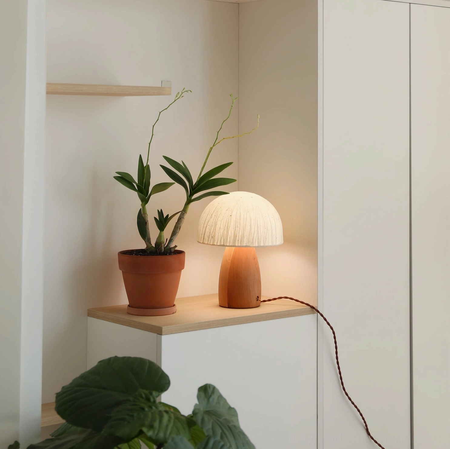 Mushroom lamp white finish variant on contemporary styled nightstand with minimal decor