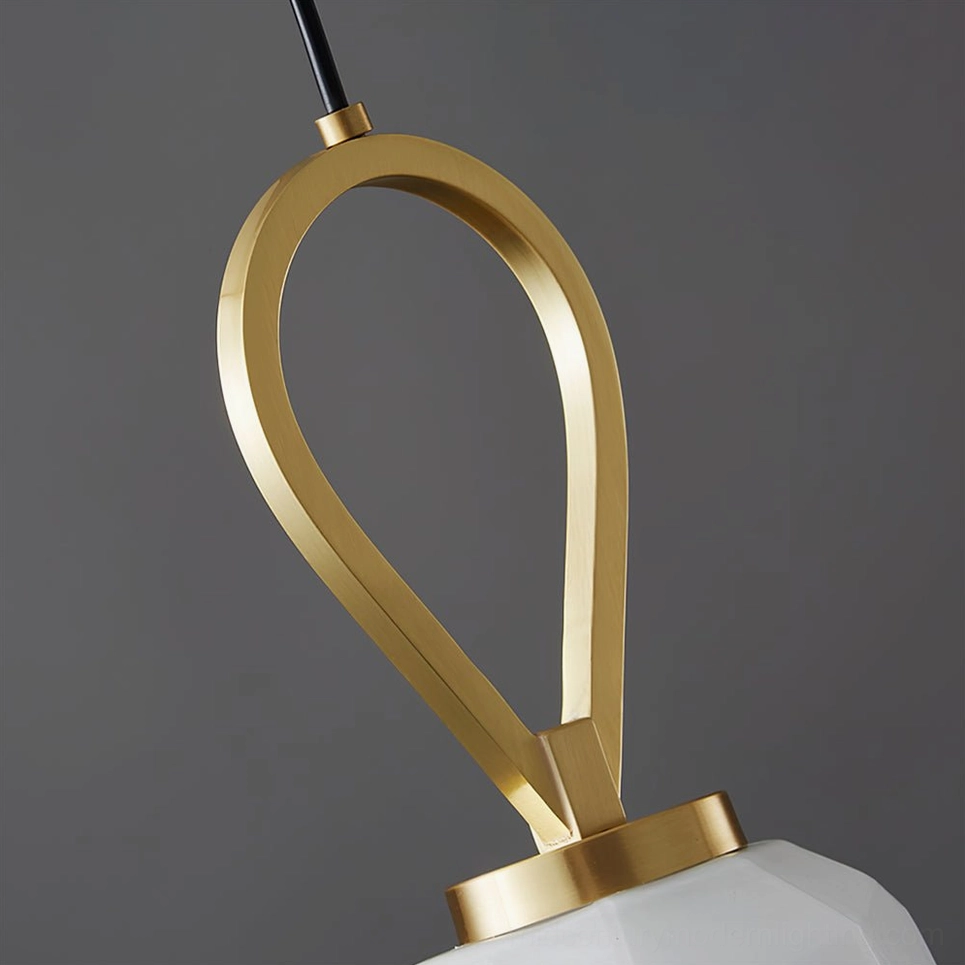 Close-up detail of Myla pendant light brass hardware and polished gold loop connector, craftsmanship detail view