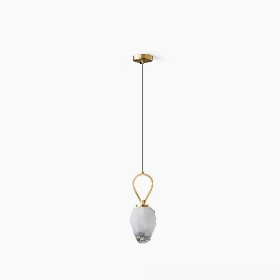 Myla faceted glass pendant light with gold brass hardware, studio overhead view showing geometric glass shade and minimalist design